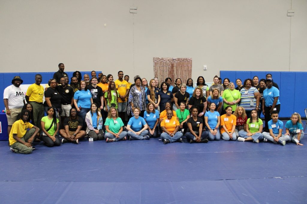 volunteers smile for a group photo at an early learning coalition event