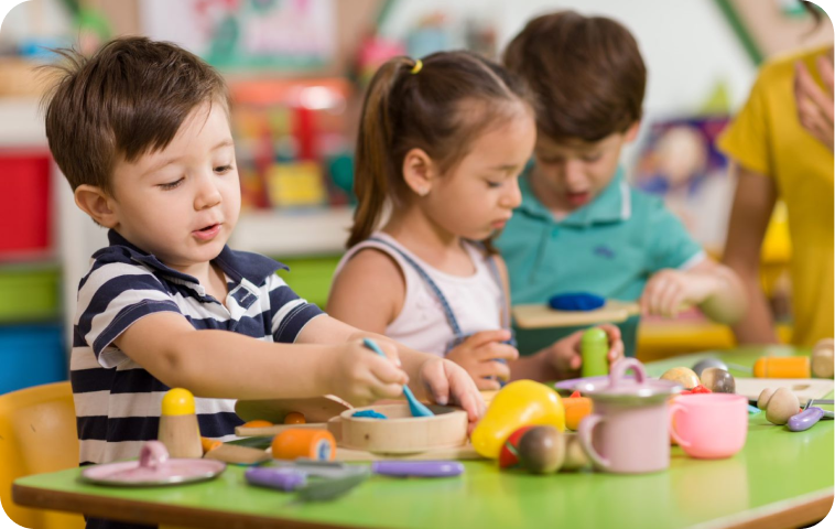 Children play with kitchen theme toys Pre-school students play with kitchen-themed toys in their early learning classroom.