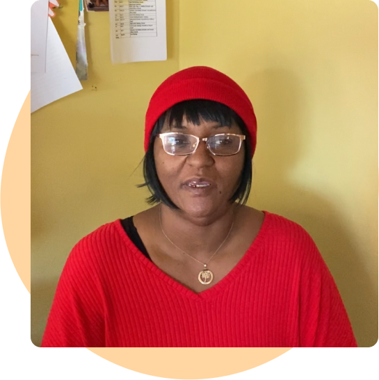 LATOSHA SHEFFIELD sits inside her early learning center. She appears confident and professional.